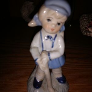 Vintage figurine of little girl holding golf club